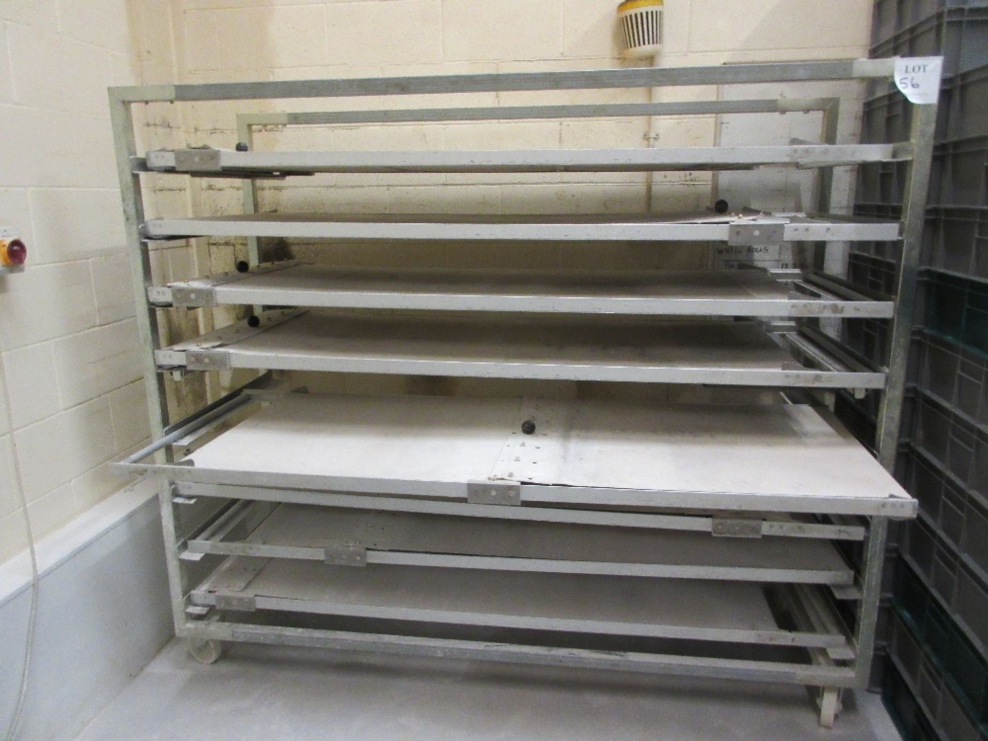 Mobile stainless eight-tier rack containing hand operated conveyors