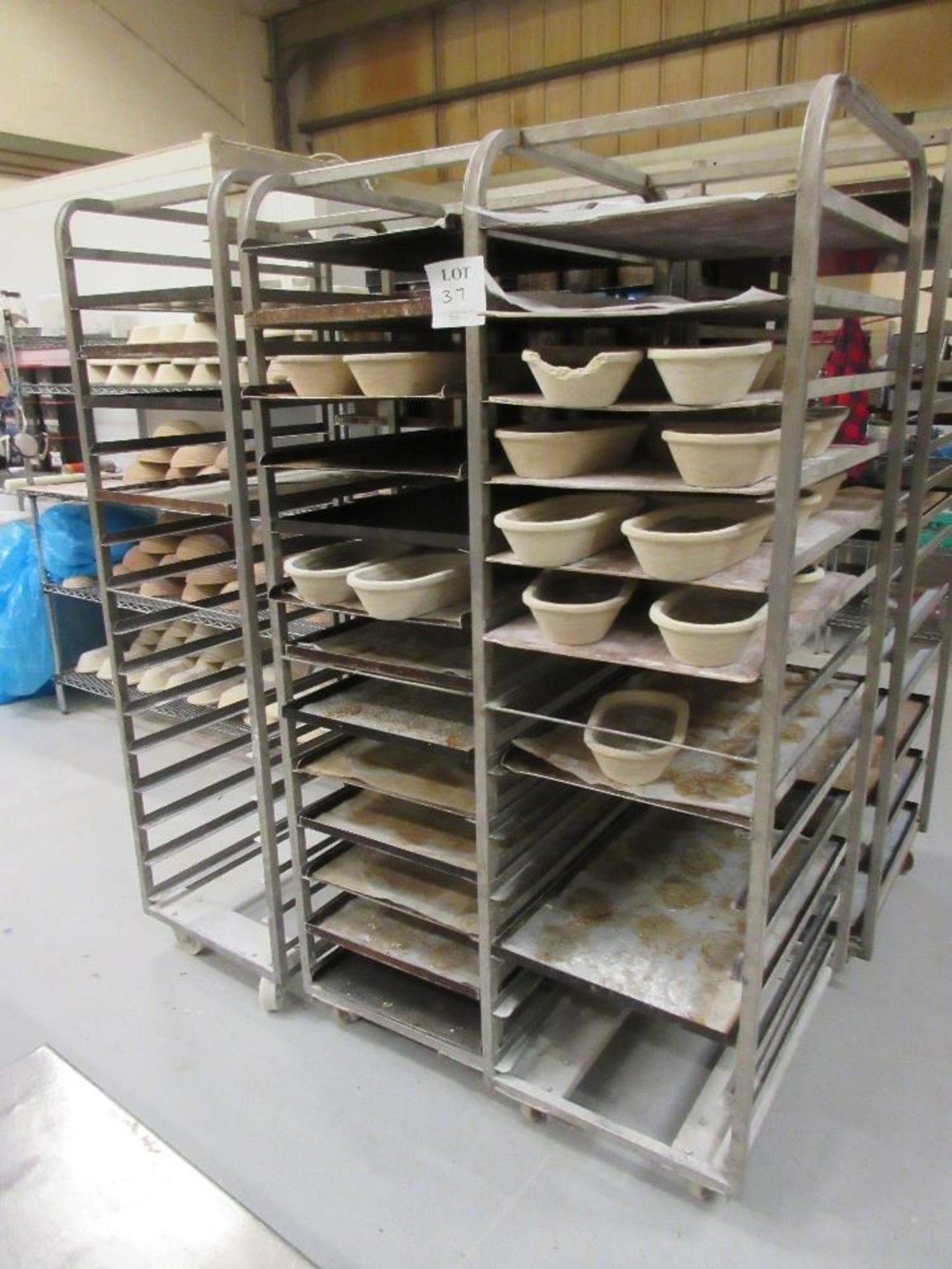 Three mobile multi-tier bread stands