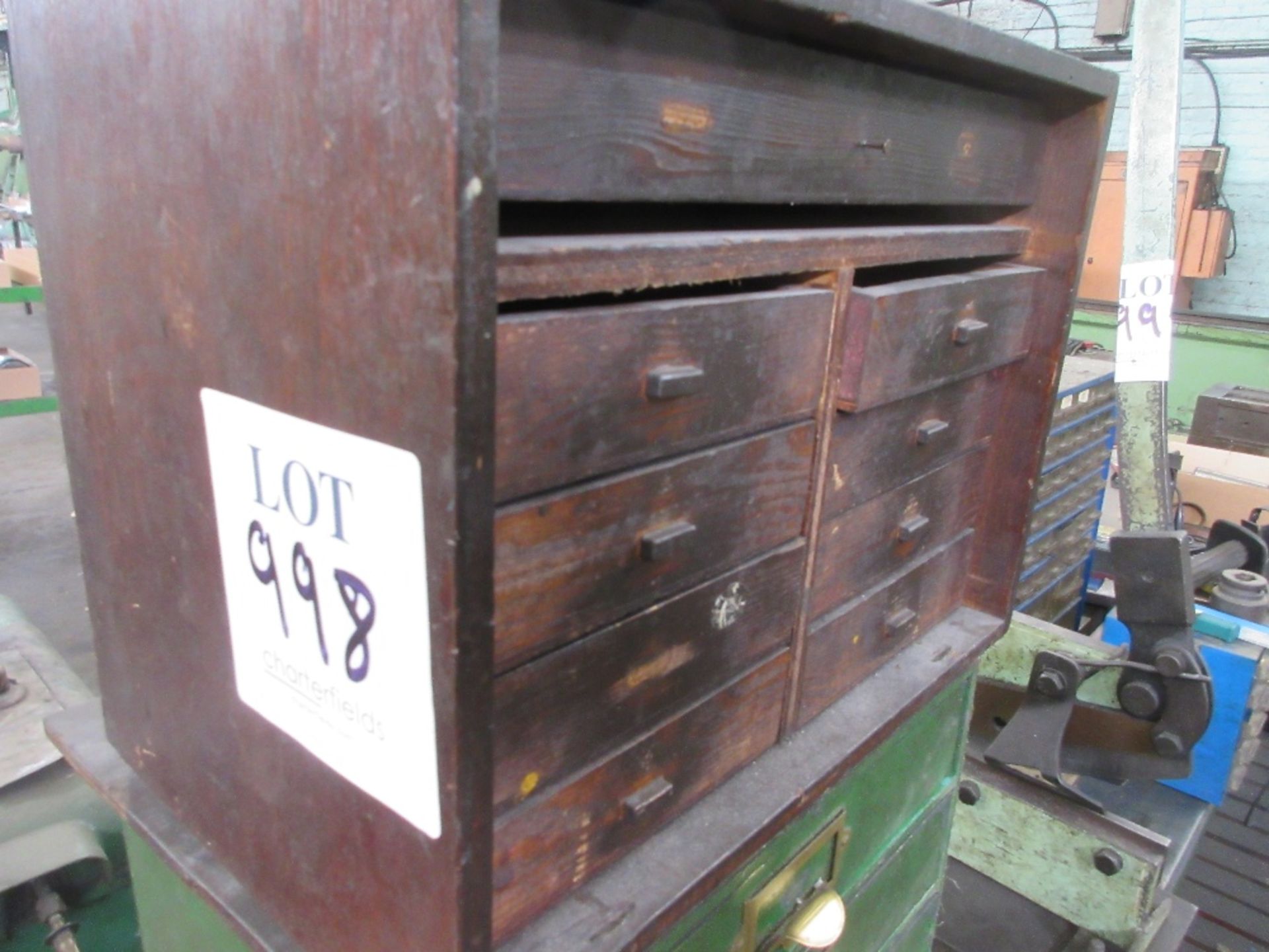 Small wooden cabinet containing various nuts bolts and various blocks