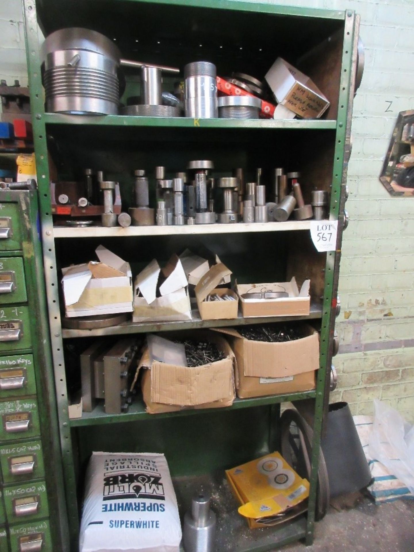 Steel shelf unit containing various gauges, boxes of nails, screws and KM locknuts