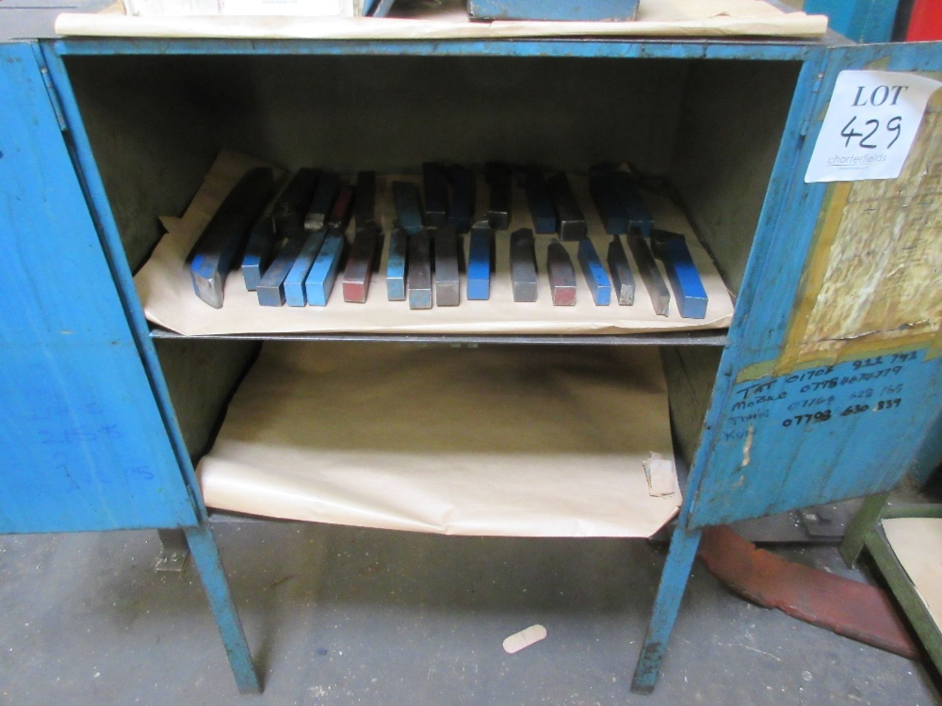 Cabinet containing lathe cutting tools