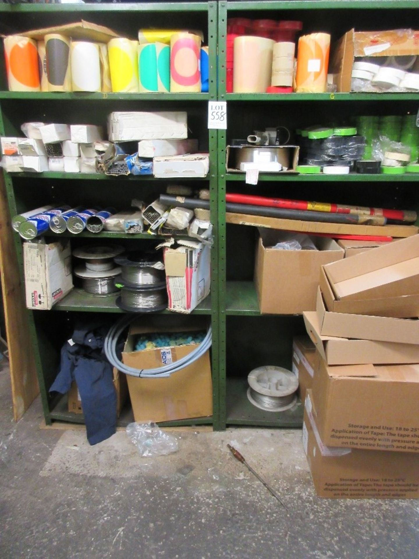 2 - steel shelves containing various welding rods, welding wire and tape and overalls