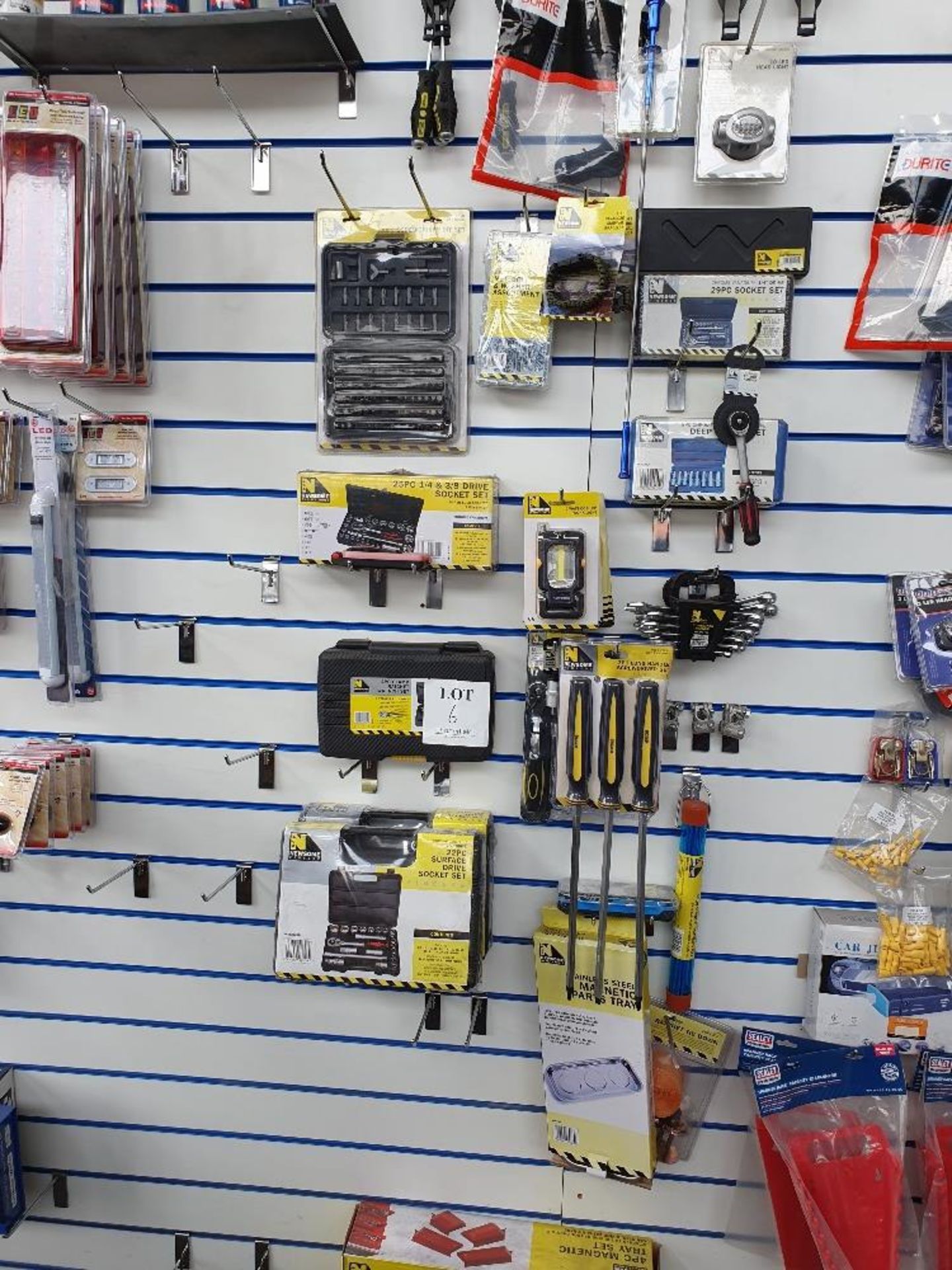 Rack of assorted socket sets, wrenches and screwdrivers