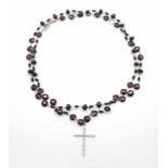 Necklace in 750 white gold with garnet and black stones, sig. Zoccai. The cross has 31 brilliants, a