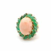 Ring is made of 750 gold with a coral, about 20 ct, dimensions 19.5 x 15 x 9.7 mm, emeralds, about 3