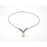 Collier tested for 585 gold with an Akoya cultured pearl and 12 brilliants, total approx. 0.60 ct in