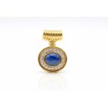 Pendant made of 750 gold with a sapphire cabochon, approx. 5.7 ct and 20 brilliants, total approx.