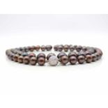 Pearl necklace, individually knotted, with 74 brownish-black South Sea cultured pearls from round to