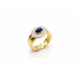 Ring made of 750 gold with a sapphire cabochon, approx. 0.60 ct and 14 brilliants, total approx. 0.