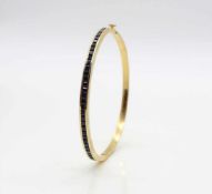 Bangle tested for 21,6 ct gold with 36 sapphires, total ca. 4 ct. The bracelet would have to be re-