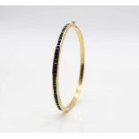 Bangle tested for 21,6 ct gold with 36 sapphires, total ca. 4 ct. The bracelet would have to be re-