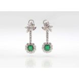 1 pair of earrings tested for platinum, plug made of 585 white gold with 1.0 ct and 1.1 ct emerald