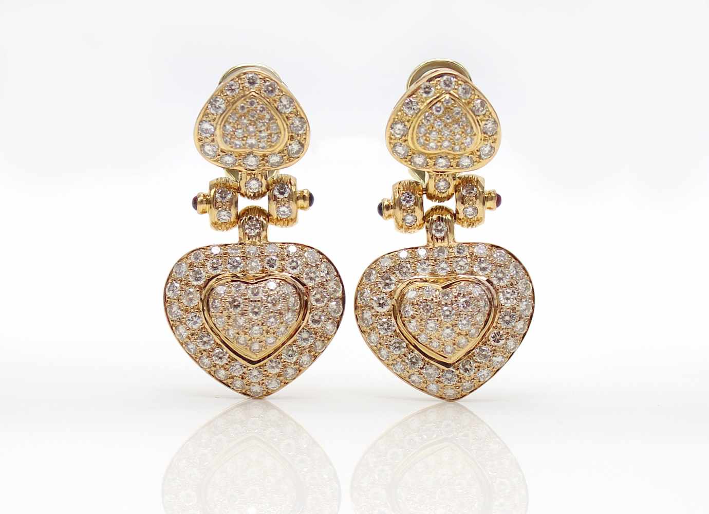 1 pair of ear studs tested for 750 gold with 2 rubies, 2 sapphires and diamonds, total approx. 4.4