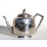 A Victorian silver plated Japanese manner teapot decorated with flowers, fans and insects, 17cms (