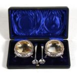 A pair of cased Victorian embossed silver salts, London 1849, with makers mark for David & Charles
