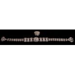 A Turkish white metal sectional belt decorated with flowers, 61cms (24ins) wide; together with a
