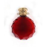 A Victorian faceted red cranberry glass scent bottle with gilt metal cap, 6cms (2.25ins) high.