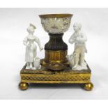 An early 18th century gilt bronze and porcelain figural group with central pierced basket on a