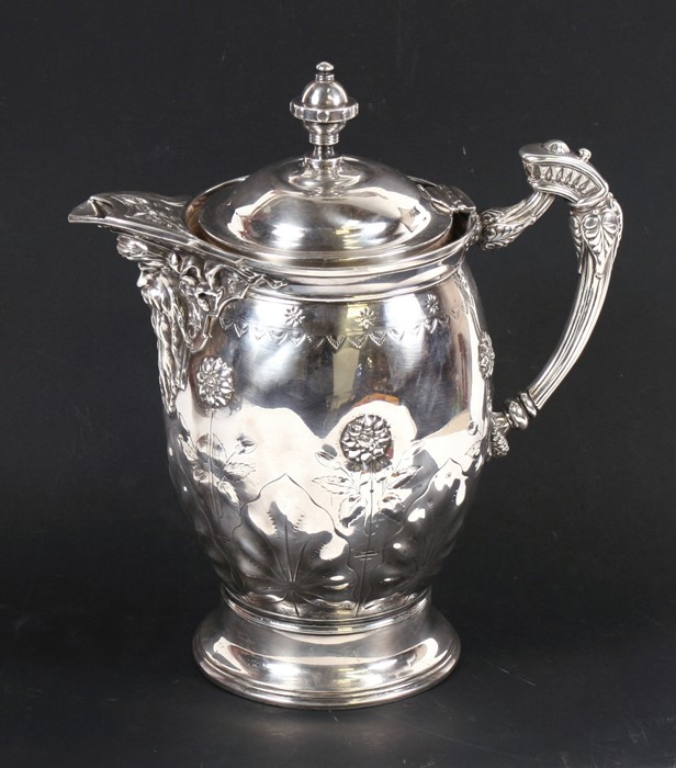 A Victorian silver plated jug with ceramic liner, decorated with flowers and having a bearded man