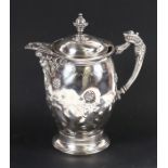A Victorian silver plated jug with ceramic liner, decorated with flowers and having a bearded man