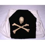 A human scull & crossbones with Masonic cloths bearing the emblem of a coffin, formally owned by a