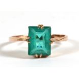 A 9ct gold dress ring set with a large rectangular cut green stone, approx UK size 'N'.Condition