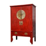 A Chinese red lacquered cupboard, the two cupboard doors above two short drawers, 115cms (45ins)