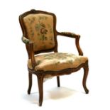 A French walnut armchair with upholstered seat and back, on cabriole front supports.