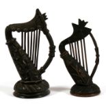 A Victorian Irish bog oak carving of a harp, 17cms (6.6ins) high; together with a similar smaller,