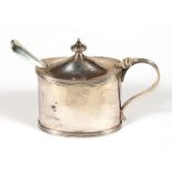 A late Victorian silver mustard pot, London 1900, with associated silver spoon, 7.5cms (3ins) high.