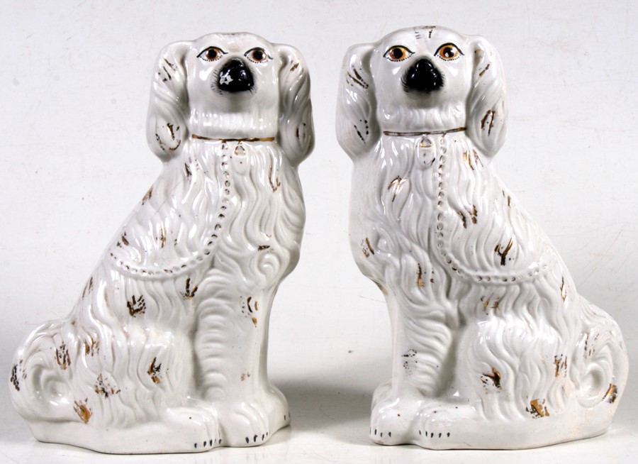 A pair of 19th century Staffordshire Spaniels, 36cms (14ins) high.Condition Report Hairline crack to