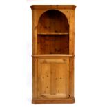 A modern antiqued pine corner cupboard, 90cms (35.5ins) wide.