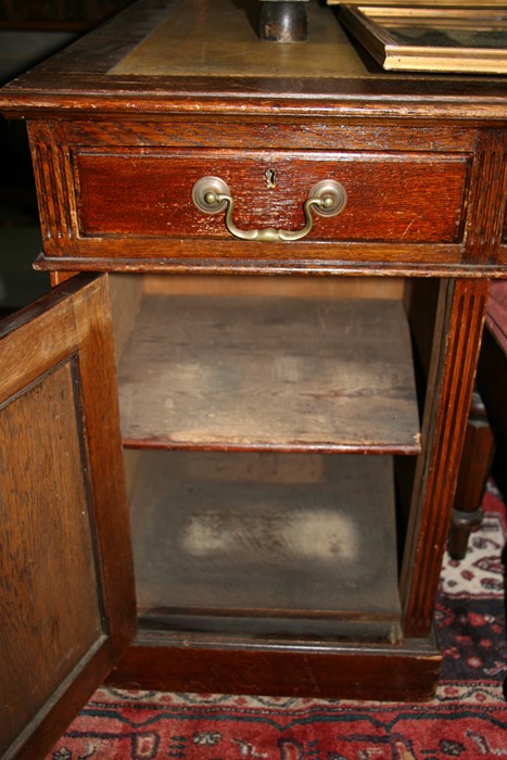 An early 20th century oak twin pedestal partner's desk, the top with green inset leather top, - Image 6 of 11