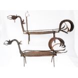 A pair of late 19th / early 20th century wrought iron stands in the form of stylised dragons,