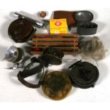 A quantity of vintage fishing items to include reels and floats.