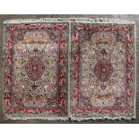 A pair of Persian rugs, the central medallion within an animal and foliate surround, 125 by