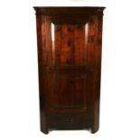 A continental walnut corner cupboard, the panelled door enclosing a shelved interior with single