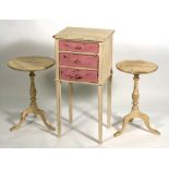 A painted mahogany bedside table on square tapering legs, 36cms (14ins) wide; together with a pair