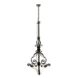 A late 19th century wrought iron adjustable standard lamp, converted to electricity.