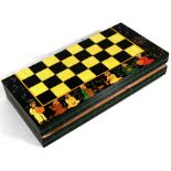 An Indian painted folding chess board with figural pieces.