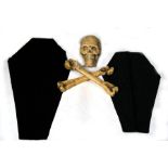 A painted plaster skull and gesso carved wooden crossbones with Masonic cloths, formally owned by