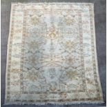 A Persian Heriz handwoven woollen carpet with stylised floral design on a cream ground, 412 by