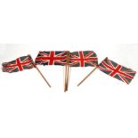 Four early 20th century British Made printed cotton patriotic Union Jack flags on poles. Flag size