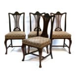 A set of four Edwardian mahogany dining chairs with pierced splats, on cabriole front supports.
