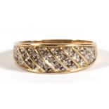 A 9ct gold diamond ring set with twenty one diamonds in diagonal rows, approx UK size 'S'.