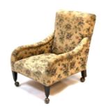 An Edwardian armchair on square tapering front supports.