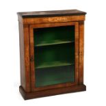 A Victorian inlaid walnut pier cabinet, the glazed door enclosing a shelved interior, 76cms (