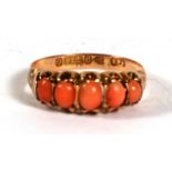 A Victorian 9ct gold ring set with five coral cabochons, Chester 1890, approx UK size 'N'.