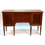 A mahogany sideboard with three central drawers flanked by cupboards, on turned reeded legs, 152.