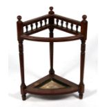 An Edwardian walnut corner stick or umbrella stand, 54cms (21.25ins) wide.